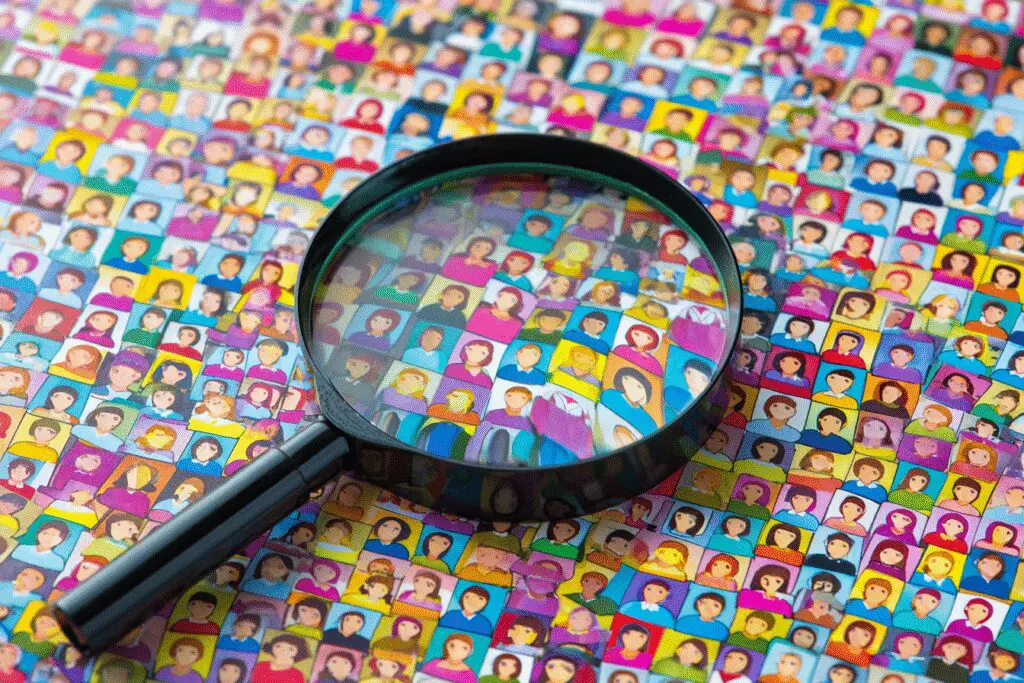A magnifying glass failing to find someone in a crowd answering can you search for someone on Hinge