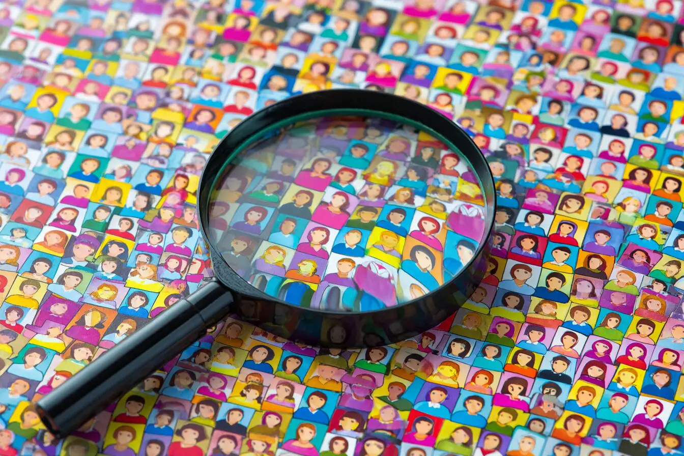 A magnifying glass failing to find someone in a crowd answering can you search for someone on Hinge