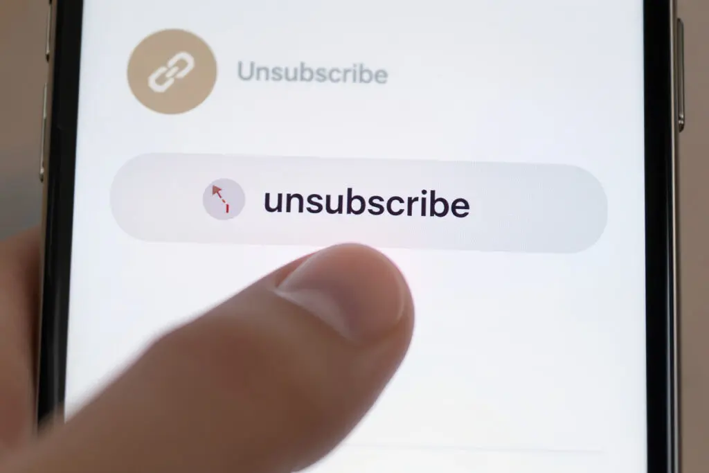 a finger tapping a cancel subscription icon on a smartphone illustrating how to cancel bumble premium