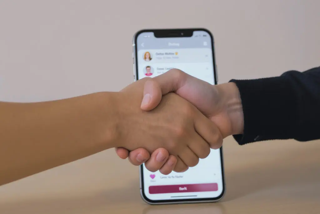a handshake symbolizing trust in front of a dating app addressing the question is bumble legit - Dating Man Secrets - Psychology Attraction Tips Revealed a handshake symbolizing trust in front of a dating app addressing the question is bumble legit