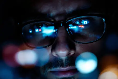 a close-up of social media stories reflected in a mans eyes a visual cue for the meaning of he watches my stories