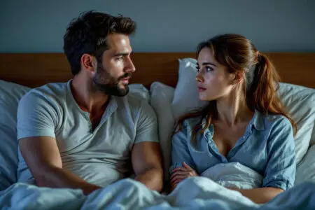 a woman with a complex thoughtful expression listening to her partner symbolizing the internal question do women care about body count