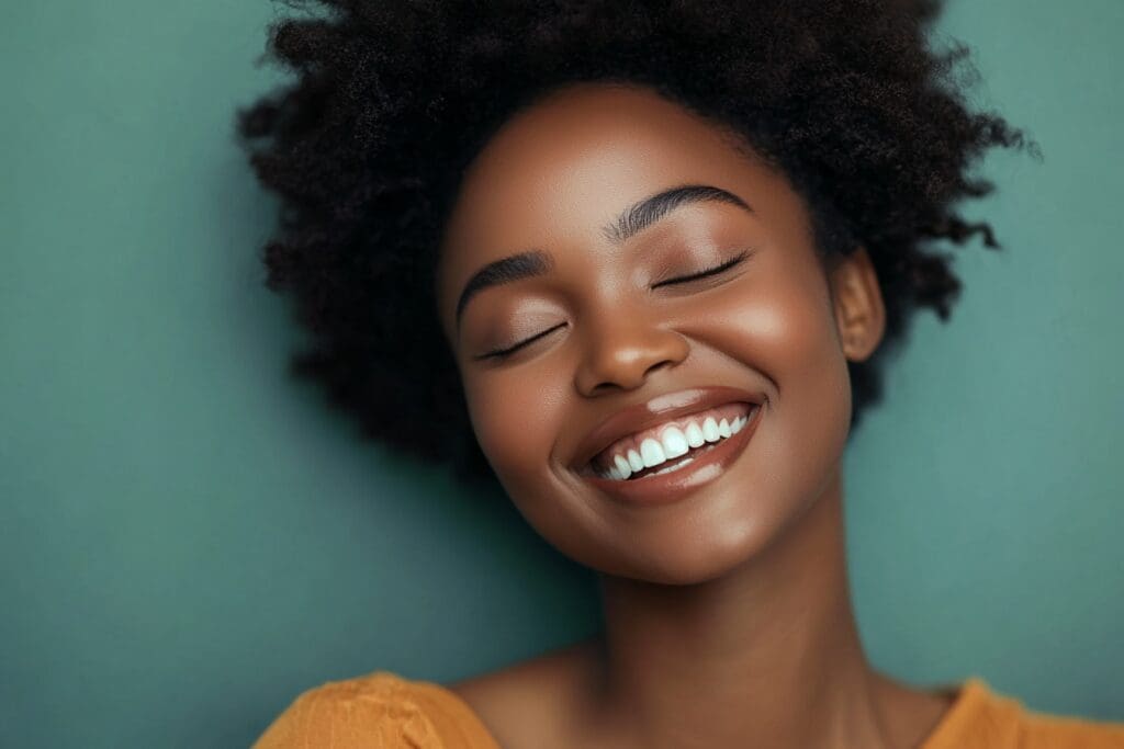 Smiling woman with closed eyes and afro hairstyle