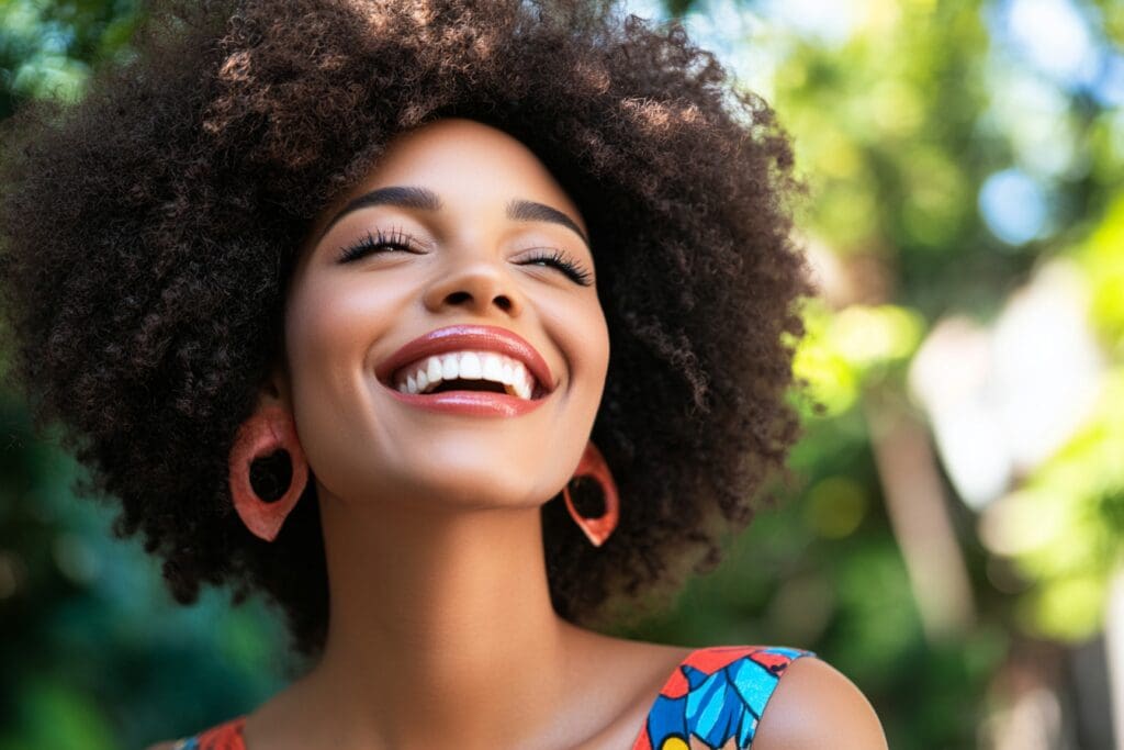 Woman smiling brightly outdoors in colorful dress