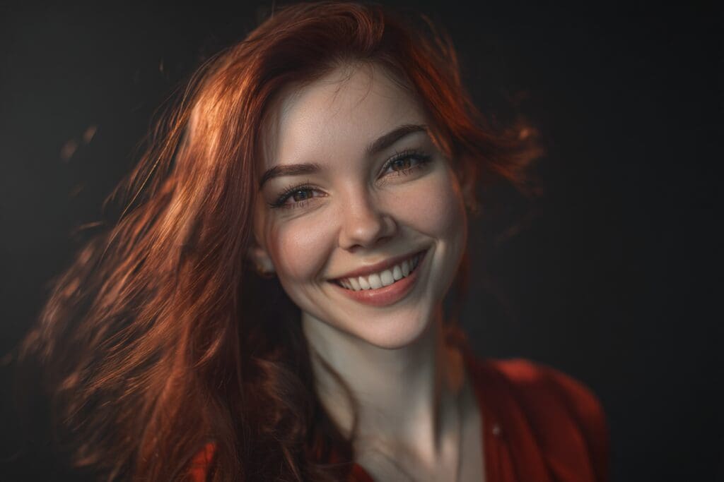 Smiling woman with vibrant red hair portrait