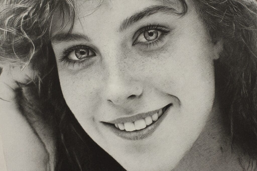 Smiling woman with expressive eyes and freckles.