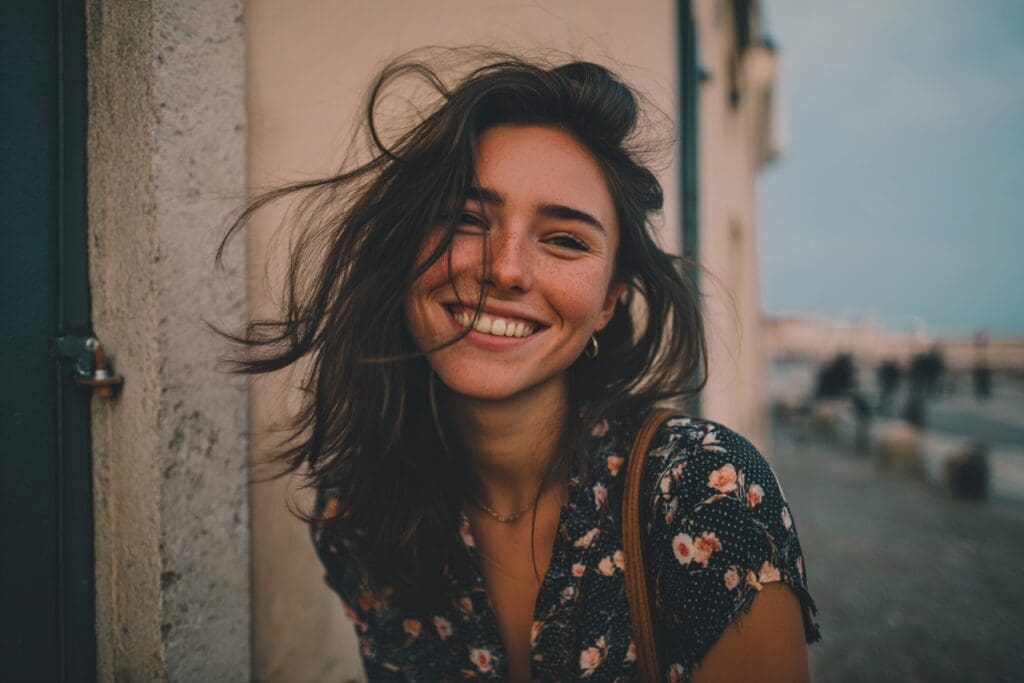 Smiling woman outdoors with windswept hair