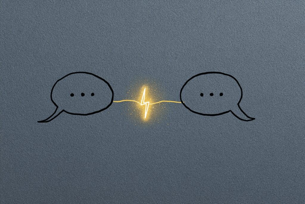 A spark between two speech bubbles illustrating the answer to the FAQ on how to flirt on Hinge