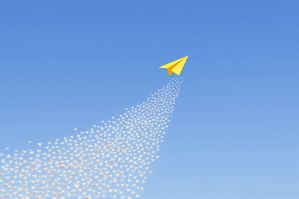 a yellow paper airplane flying above the rest symbolizing the advantage of what is bumble boost